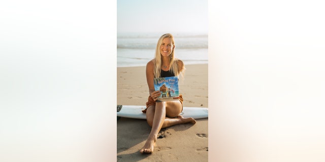 Bethany Hamilton is shown with a copy of her latest book, "Surfing Past Fear" (Brave Books). 