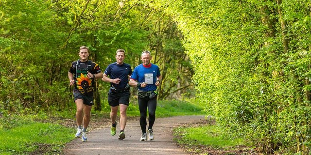Through rain or shine, McKee (above, far right) was determined to run 26.2 miles every day during the year of 2022.