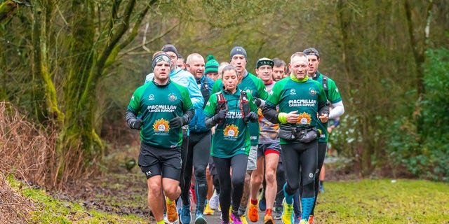 McKee (far right, front) raised about $1.2 million for Macmillan Cancer Support and Hospice at Home West Cumbria.