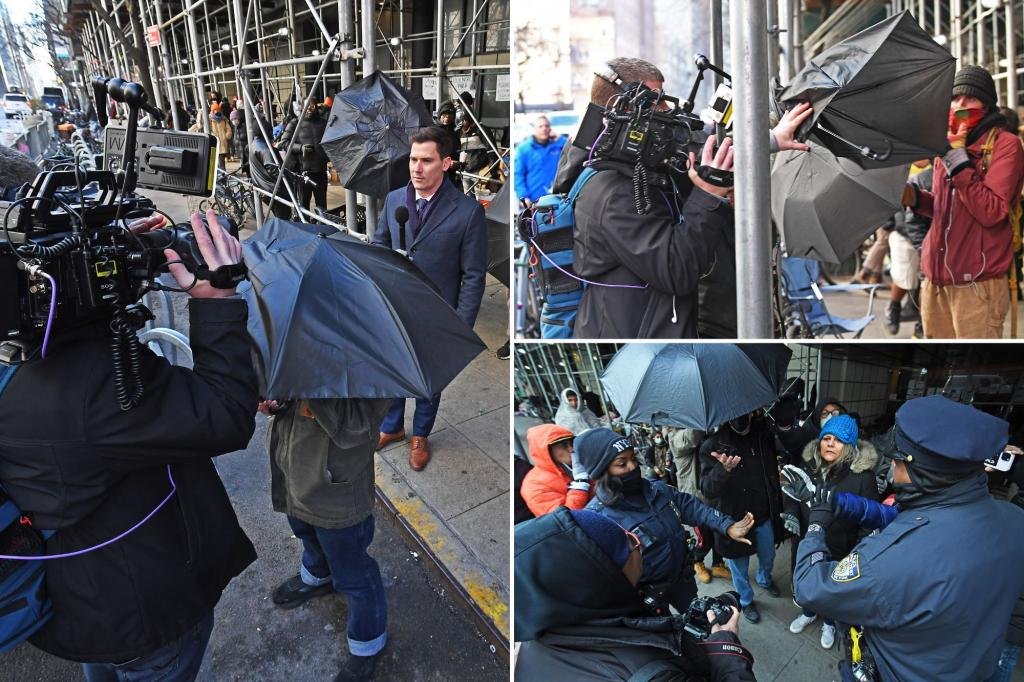 Migrant standoff in NYC turns ugly as 10 outside activists move against media with open umbrellas