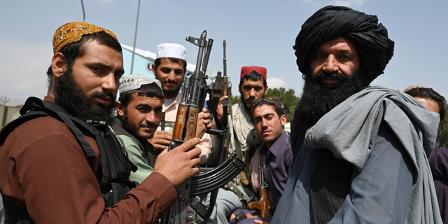 Taliban militants holding rifles. The Taliban has used Twitter for years and has praised Elon Musk since he purchased the platform.