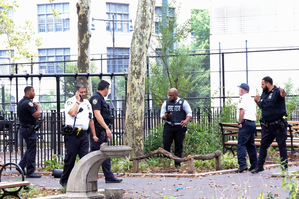 NYPD cops search McLaughlin Park for evidence.
