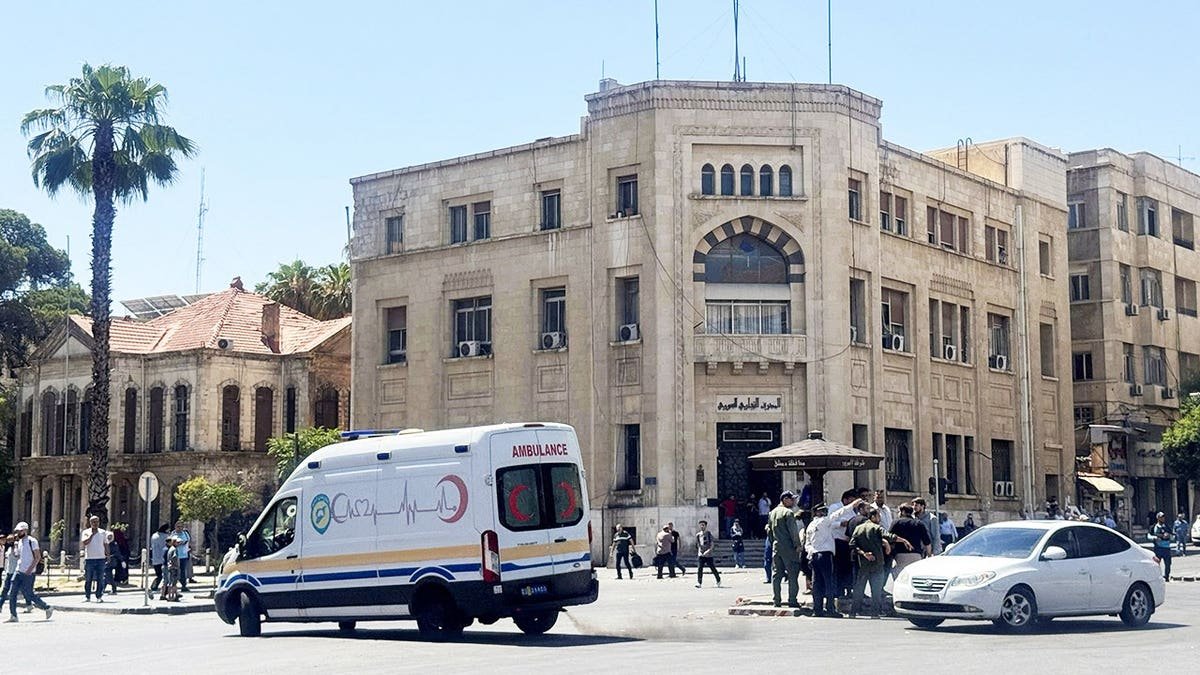 An ambulance drives past the site where explosive devices blew up near a hotel where French President Emmanuel Macron was meant to be staying, in Damascus, Syria, July 7, 2026.
